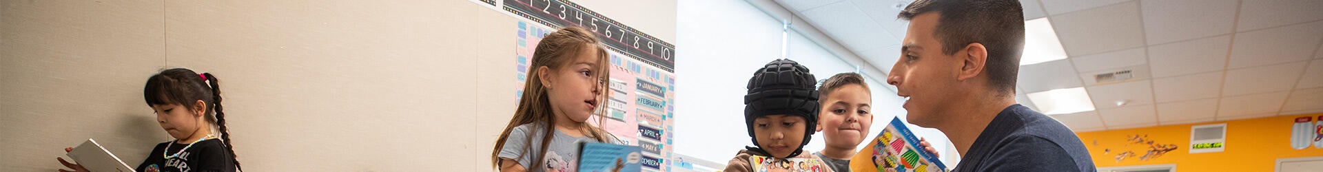School teacher speaking with children